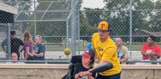 A University of Toledo baseball player volunteering with Miracle League of Northwest Ohio.