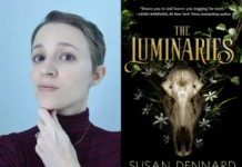 Susan Dennard next to the cover of her book, The Luminaries.